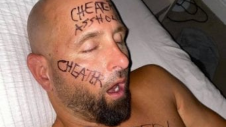 Karl Anderson's wife wrote cheater on his face.